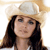 Pixelated image of a person with long dark hair wearing a light-colored cowboy hat against a white background.