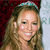 A pixelated portrait of a smiling person with long light brown hair wearing a teal headband against a dark red and light blue background.