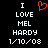 Black background with white pixelated text reading "I LOVE MEL HARDY 1/10/08" and a red pixelated heart symbol above "LOVE".