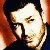 A pixelated contact sheet showing two frames of an animated icon featuring a person's face on the left and green text reading "Original Icons .com" on the right against a dark background.