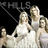Three women in white dresses pose against a black background with pink text reading "love isnt a maybe thing... -the hills".