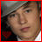 A 48x48 pixel animated contact sheet showing two frames of a person wearing a gray cap and white shirt with red heart symbols in the bottom-left corner, one frame darker than the other.