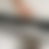 A pixelated image with horizontal bands of muted grays and soft peach tones, lacking distinct subjects or text.