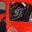 A static pixelated image shows a dark, abstract shape with swirling patterns against a bright red background.