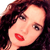 Pixelated close-up of a person with dark brown hair, light skin, and red lips, cropped to show face and upper shoulders.
