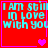 Red background with cyan text reading "I AM STILL IN LOVE WITH YOU" and pink heart symbols in four quadrants.