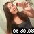 A pixelated image shows a person with long brown hair holding a red and white bottle near their face, wearing a dark gray sleeveless top with a large cutout on the chest, against a light beige background with a black banner displaying "05 30 08" in white pixelated numbers.