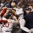 Pixelated image of baseball players celebrating on left, red background with black text 'WORLD SERIES CHAMPS' on right.