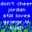 Blue background with white pixelated text repeating 'don't cheer', 'jordan', 'still loves', 'george w.', and 'bush' in two above green grass-like pixels