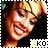 A pixelated image of a smiling person with blonde hair in a high ponytail, wearing a dark top, with 'AKO' text below.