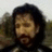 Pixelated image of a person with dark hair and beard, next to pixelated text reading "I will cut your heart out with a spoon!" on white background.