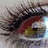 A pixelated image split into two sections: a blurry left side with dark and light tones, and a right section featuring rainbow stripes with text.