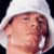 Pixelated image of a person wearing a white hooded garment with repeated text "Sexy Sexy Cena" on the right side against black background.