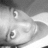 Pixelated grayscale image of a stylized face with closed eyes and a rounded nose, set against a gradient background.