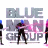 Static 48x48 pixel icon featuring stylized text "BLUE MAN GROUP" with three silhouetted figures in front, rendered in grayscale and pink/purple hues on a white background.