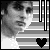 Black-and-white pixelated image of a person in a striped background with heart symbols changing