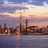Pixelated cityscape at dusk with water reflection and red text overlay reading "you're 100 miles but tonight you" on white background.
