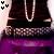 Pixelated image showing dark pants with a silver chain, pinkish background, and purple lower section.