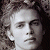 Pixelated grayscale portrait of a person with curly hair on left, green background with bright green text 'Original Icons .com' on right.