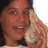 A pixelated image shows a person holding a small animal against a light background with blue text reading 'Shello?' on the right.