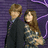 Two figures stand side-by-side against a purple striped background; one figure wears dark clothing while the other has long brown hair and patterned attire.
