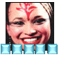 A smiling person with red forehead markings and light brown hair, wearing a blue pixelated wordwall below the face.