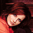 Two side-by-side pixelated images of a person with long brown hair, one in dark clothing against a red background and the other in light clothing against a neutral backdrop.