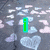 Animated sequence showing text changes over a heart-patterned background with shifting colors.
