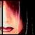 Pixelated close-up of a person's face showing lips and part of the nose with warm color tones against dark background.