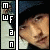 six pixelated images showing a person in a dark beanie and light jacket, with changing colored letters on the left side