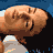 Pixelated image of a person with light brown hair and a white top, viewed from above against a blue background.