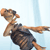 Pixelated figure in dark outfit with light skin and brown hair, arm extended right, head tilted back, against light blue background.