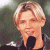 A pixelated contact sheet showing two frames of an animated icon featuring a person with light hair holding a microphone on the left and green text reading "Original Icons .com" on the right against a dark background.