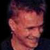 Pixelated static image of a person's face with reddish skin tones and dark hair against a black background, appearing as an AOL Instant Messenger buddy icon.
