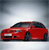 Red sedan car in side profile view with dark roof, positioned on light surface against gradient background.