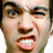 Pixelated close-up of a person's face showing eyes, nose, mouth with teeth visible and partial hairline against white background.