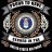 A pixelated emblem with a central blue and white circular design surrounded by brown, gray, and green elements on a black background.