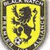 A yellow shield with a black rampant lion, bordered by dark gray and white pixels; next to it is a soccer ball with black text reading "Soccer!!!" on a white background.