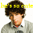 A pixelated image of a person with curly brown hair wearing a light gray sweater over a white collared shirt, with yellow text overlays reading "he's so cute he's the best" and "it's nick jonas".