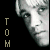 A pixelated grayscale image of a person's face in four quadrants with vertical text on the left side.