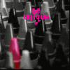 Pixelated image with grayscale background of repeated abstract shapes and a single pink lipstick tube in foreground, overlaid with pink text "be unique" and a small heart symbol.