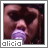 Alicia Keys singing into a purple microphone with a dark background, displayed in a of identical frames