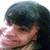 Pixelated close-up of a person's face with dark hair, showing partial facial features and light skin tones.