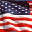 Static pixelated image of a waving American flag with red and white stripes and a blue field of white stars.