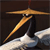 A pixelated image of a golden cymbal and drumstick on a dark background with a white drum head visible below.