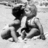 Black-and-white pixelated image of two figures in a kiss pose with pink text reading "a kiss can mean a 1,000 words" on the right.