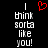 A black background displays two identical pixelated text blocks reading "I think sorta like you!" with a red heart symbol above the left block.