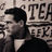 Pixelated grayscale image of a person with dark hair in profile, wearing a collared shirt and jacket, positioned next to large blocky text reading "TECH" above "REK".