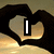 Animated icon shows hands forming a heart shape with changing symbols inside: vertical bar, arrow and number, horizontal bar.