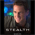 Pixelated static image of a person's face with the word "STEALTH" below, set against a blurred background with blue and green lights.